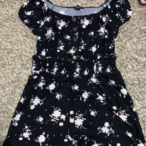 A black romper with light pink roses
